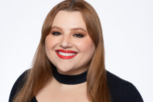 Smiling woman in headshot with great makeup and lipstick.