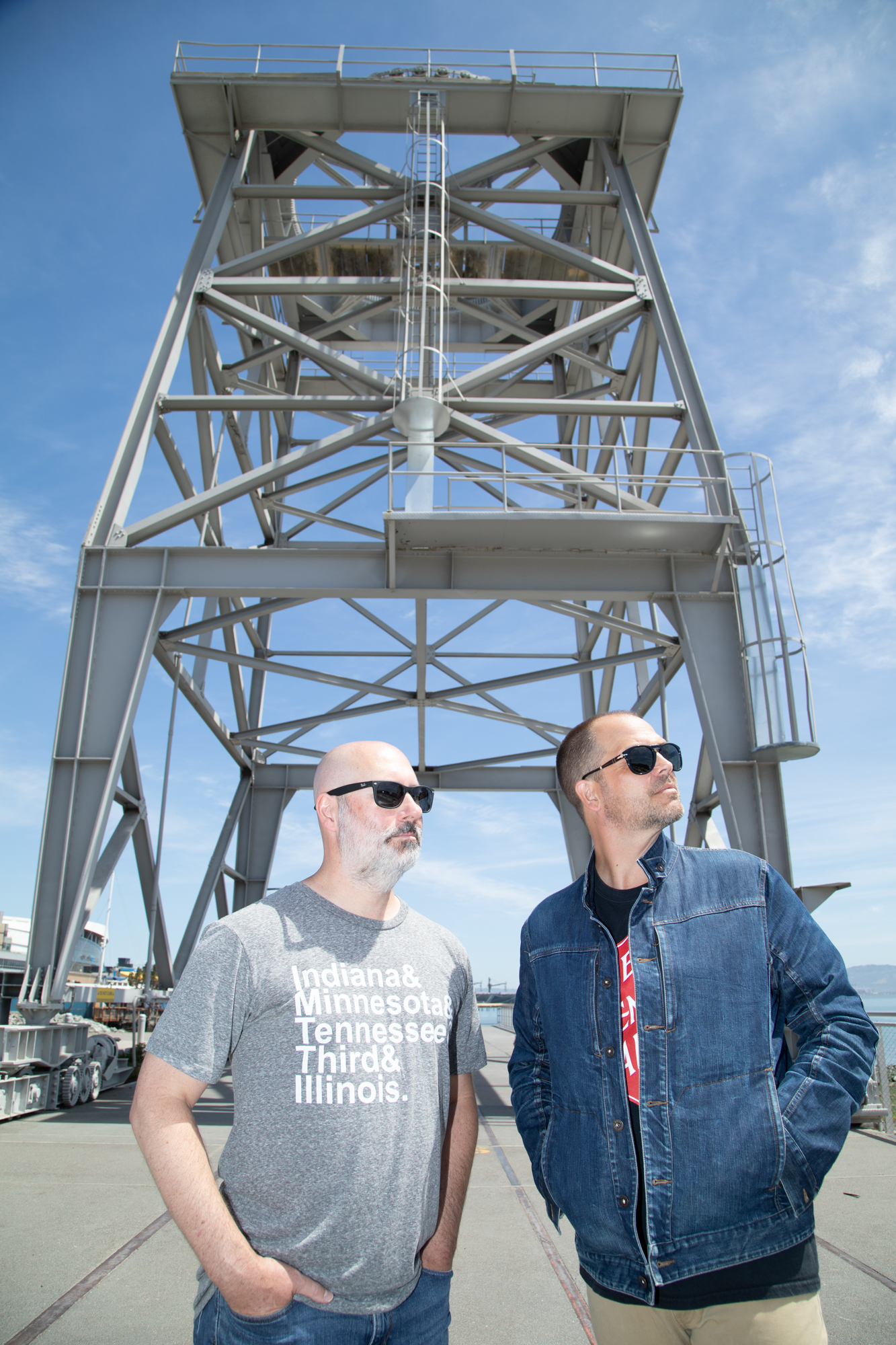 Two Men in Sunglasses under a crane structure