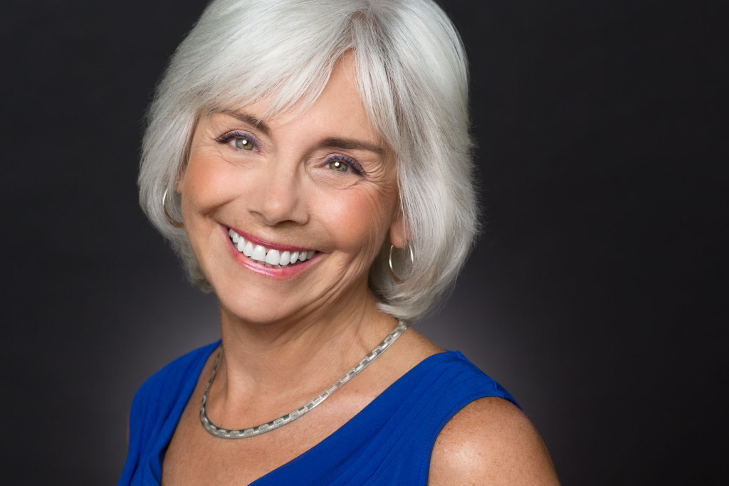 Headshot of Actress with grey hair and smile with color correction makeup