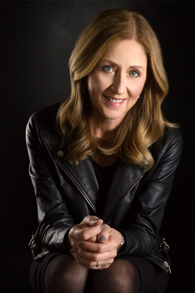 Portrait of Smiling woman with green eyes in Leather Jacket