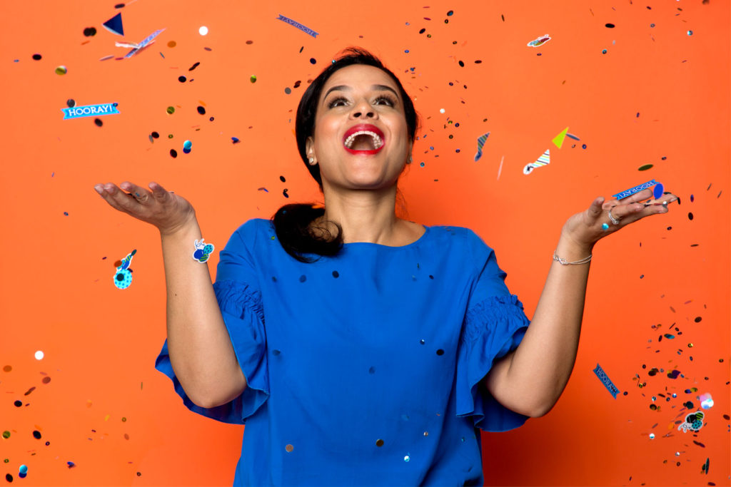 Woman throwing confetti in the air for personal branding.