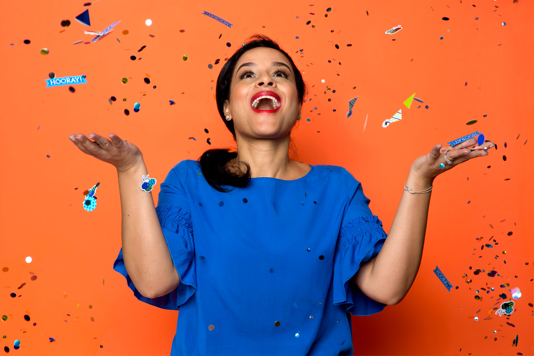 Woman throwing confetti in the air for personal branding.