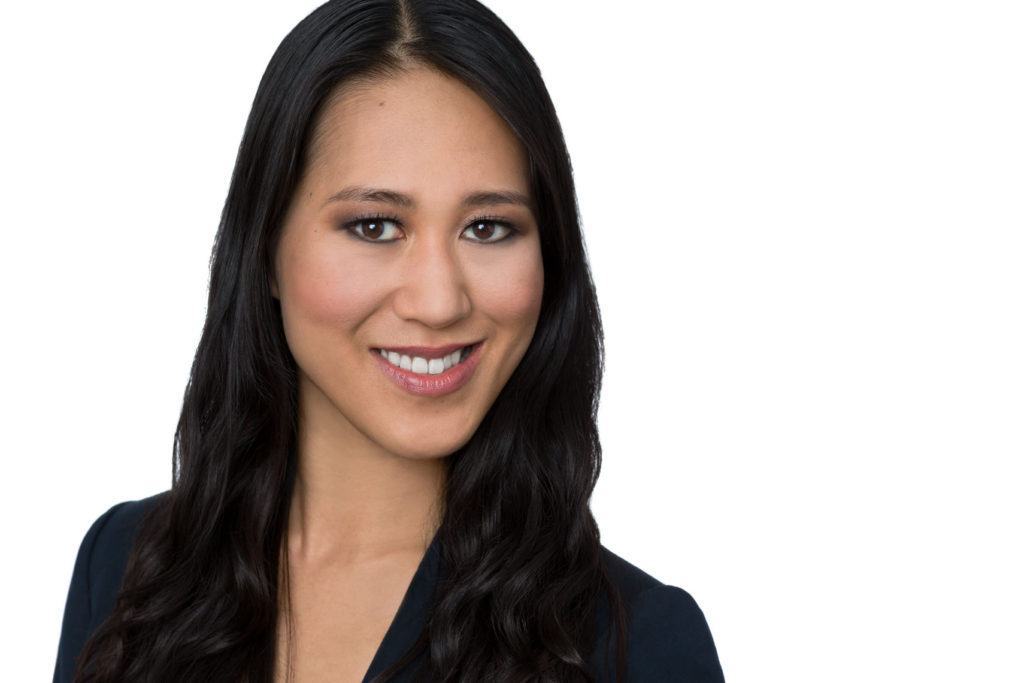 Headshot of smiling woman with color correction makeup